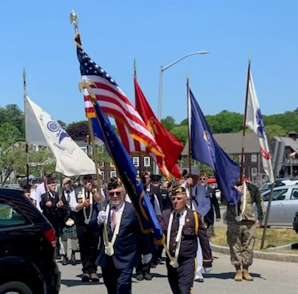 Veterans and community members marching in a Manchester remembrance procession